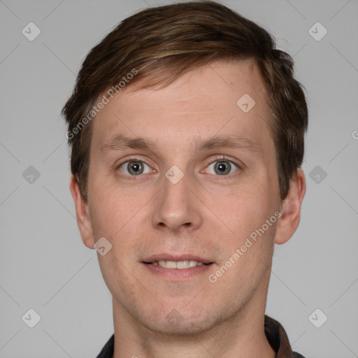 Joyful white young-adult male with short  brown hair and grey eyes