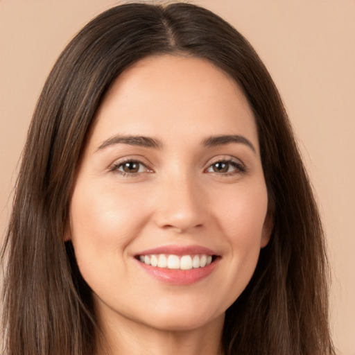 Joyful white young-adult female with long  brown hair and brown eyes