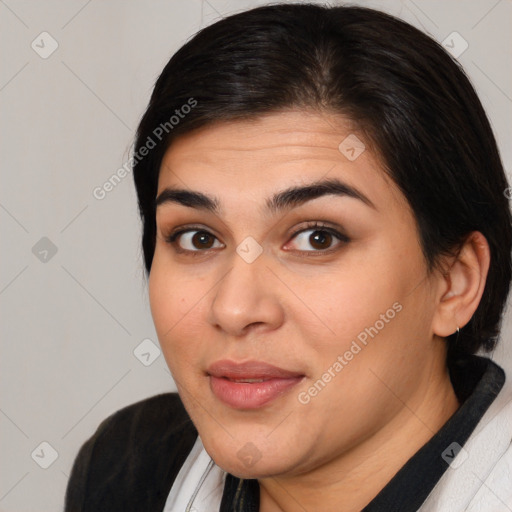 Joyful latino young-adult female with medium  brown hair and brown eyes