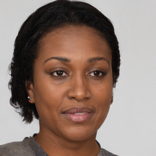 Joyful black adult female with short  brown hair and brown eyes