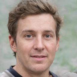 Joyful white adult male with short  brown hair and grey eyes