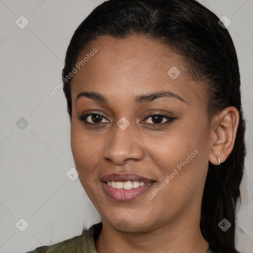 Joyful black young-adult female with long  brown hair and brown eyes