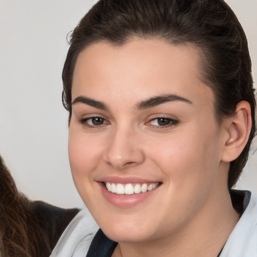 Joyful white young-adult female with medium  brown hair and brown eyes