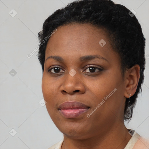 Joyful black young-adult female with short  black hair and brown eyes