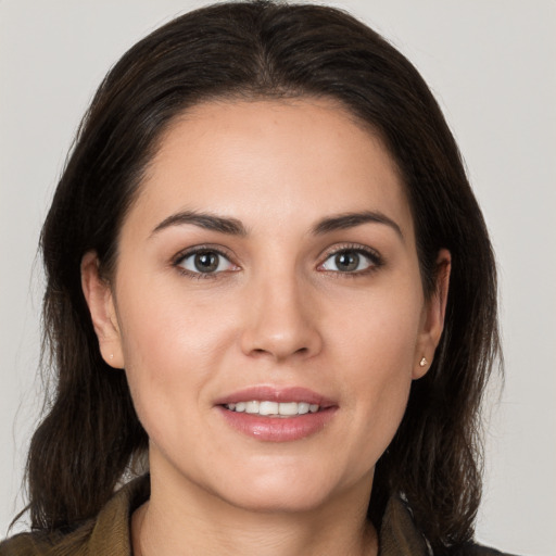 Joyful white young-adult female with medium  brown hair and brown eyes