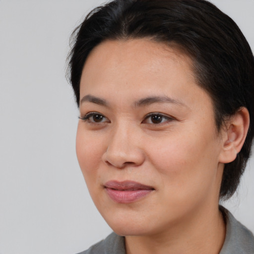 Joyful white young-adult female with short  black hair and brown eyes