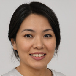 Joyful asian young-adult female with medium  black hair and brown eyes