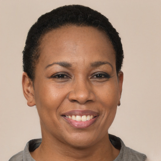 Joyful latino adult female with short  brown hair and brown eyes