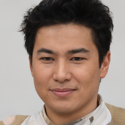Joyful asian young-adult male with short  brown hair and brown eyes