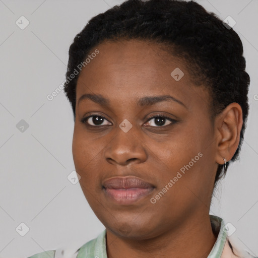 Joyful black young-adult female with short  black hair and brown eyes