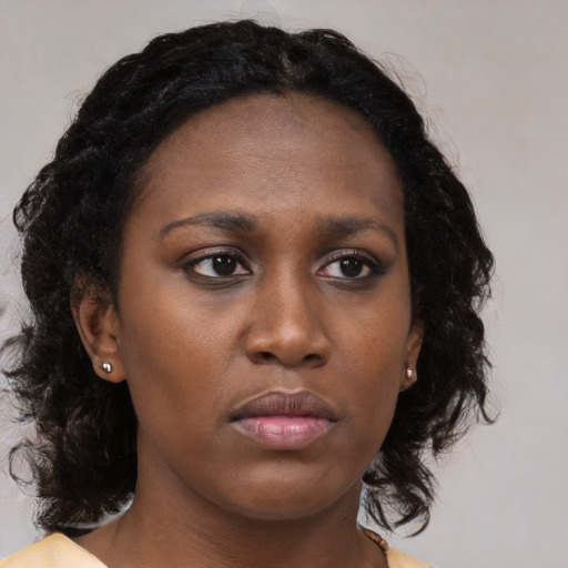 Neutral black young-adult female with medium  brown hair and brown eyes