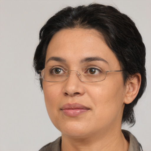 Joyful latino adult female with medium  brown hair and brown eyes