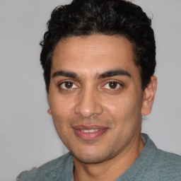 Joyful white young-adult male with short  black hair and brown eyes