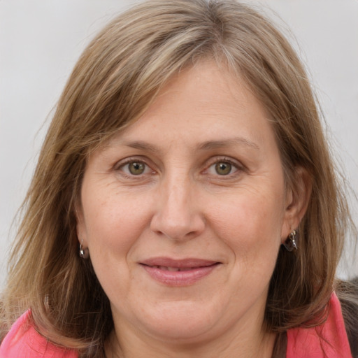 Joyful white adult female with long  brown hair and grey eyes