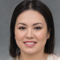 Joyful asian young-adult female with long  brown hair and brown eyes