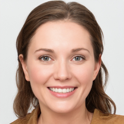 Joyful white young-adult female with medium  brown hair and grey eyes