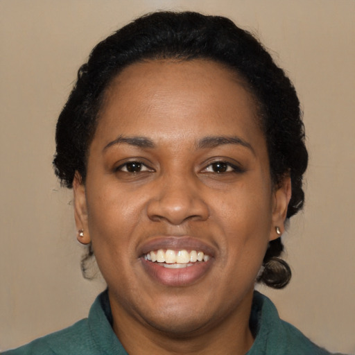 Joyful black adult female with medium  black hair and brown eyes