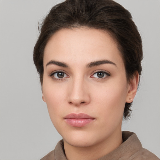 Neutral white young-adult female with short  brown hair and brown eyes