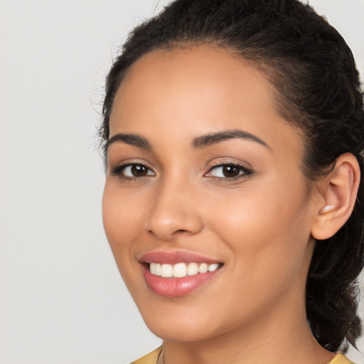 Joyful latino young-adult female with long  brown hair and brown eyes