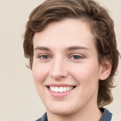 Joyful white young-adult female with medium  brown hair and green eyes