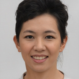 Joyful asian young-adult female with short  brown hair and brown eyes