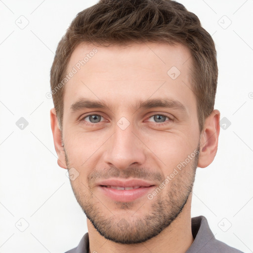 Joyful white young-adult male with short  brown hair and grey eyes