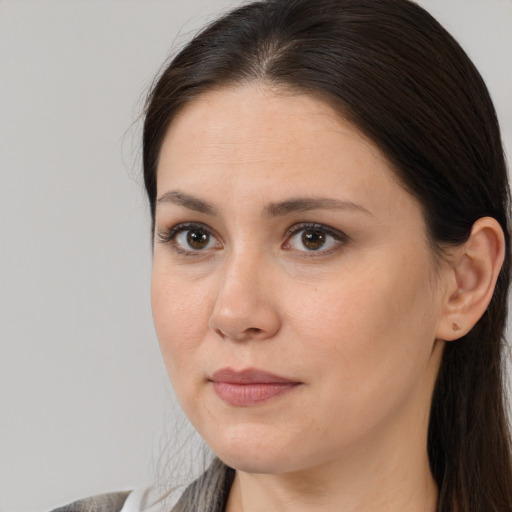 Joyful white young-adult female with long  brown hair and brown eyes