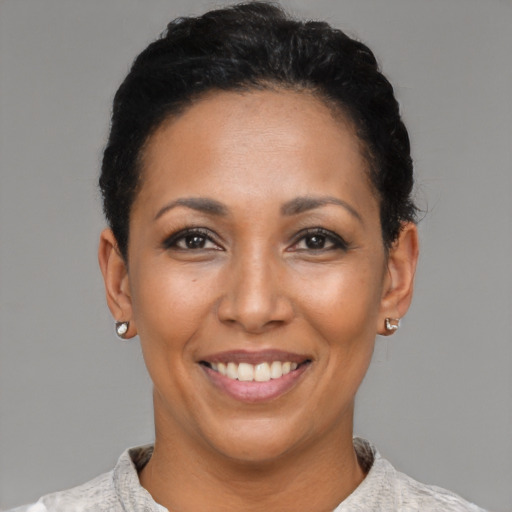 Joyful latino adult female with short  black hair and brown eyes