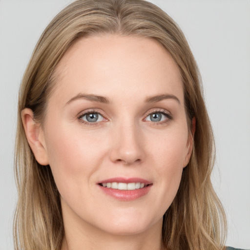 Joyful white young-adult female with long  brown hair and blue eyes