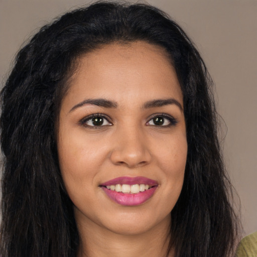 Joyful latino young-adult female with long  brown hair and brown eyes