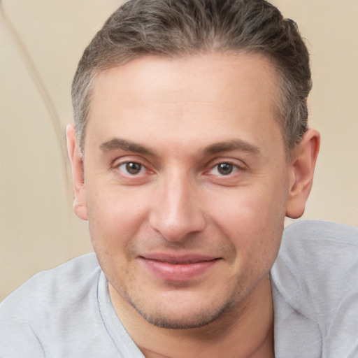 Joyful white adult male with short  brown hair and brown eyes