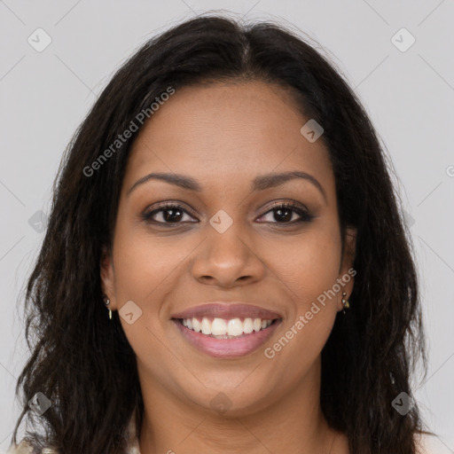 Joyful black young-adult female with long  brown hair and brown eyes