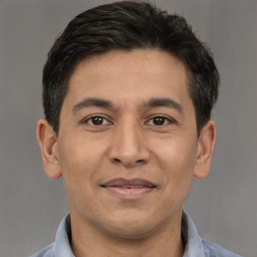 Joyful white adult male with short  brown hair and brown eyes