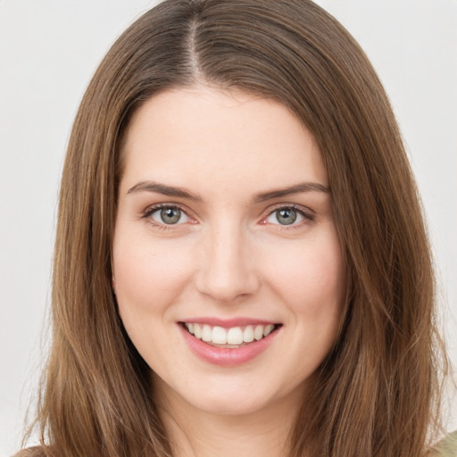 Joyful white young-adult female with long  brown hair and green eyes