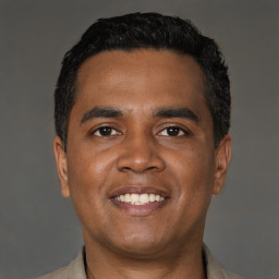 Joyful black young-adult male with short  black hair and brown eyes