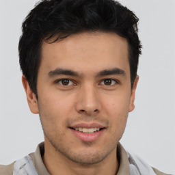 Joyful latino young-adult male with short  brown hair and brown eyes