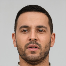 Neutral white young-adult male with short  black hair and brown eyes