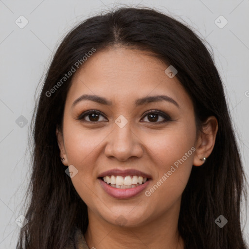 Joyful latino young-adult female with long  brown hair and brown eyes