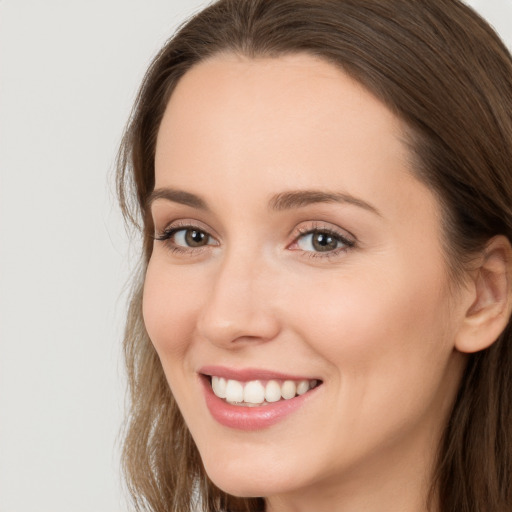 Joyful white young-adult female with long  brown hair and grey eyes