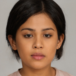 Neutral asian young-adult female with medium  brown hair and brown eyes