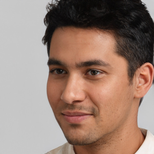 Joyful white young-adult male with short  black hair and brown eyes