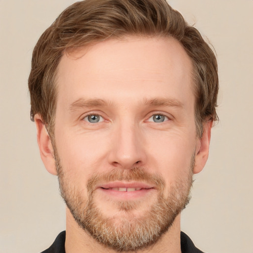 Joyful white adult male with short  brown hair and grey eyes