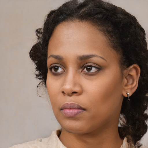 Neutral black young-adult female with medium  brown hair and brown eyes