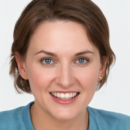 Joyful white young-adult female with medium  brown hair and blue eyes