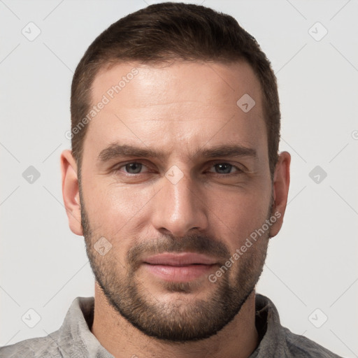 Joyful white young-adult male with short  brown hair and grey eyes