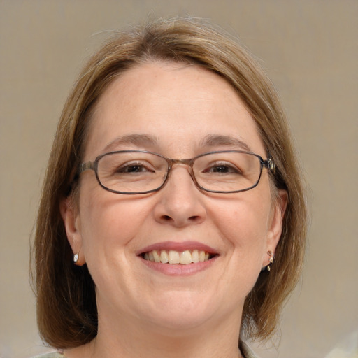 Joyful white adult female with medium  brown hair and blue eyes