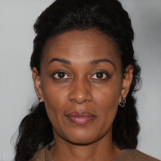 Joyful black young-adult female with medium  brown hair and brown eyes