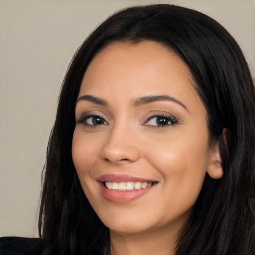 Joyful latino young-adult female with long  black hair and brown eyes