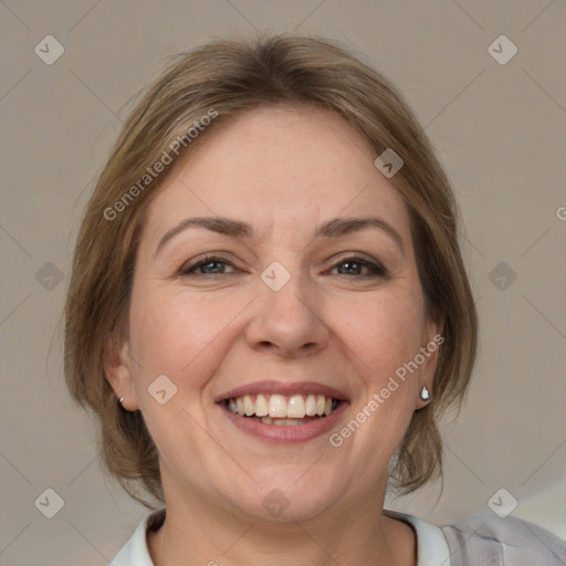 Joyful white adult female with medium  brown hair and blue eyes