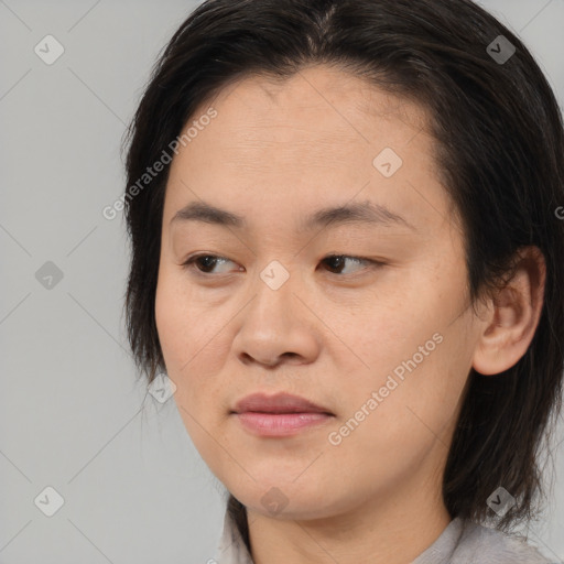 Joyful asian young-adult female with medium  brown hair and brown eyes